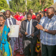 Recognized as a Kenyan at last, with president Uhuru Kenyatta, second from right.